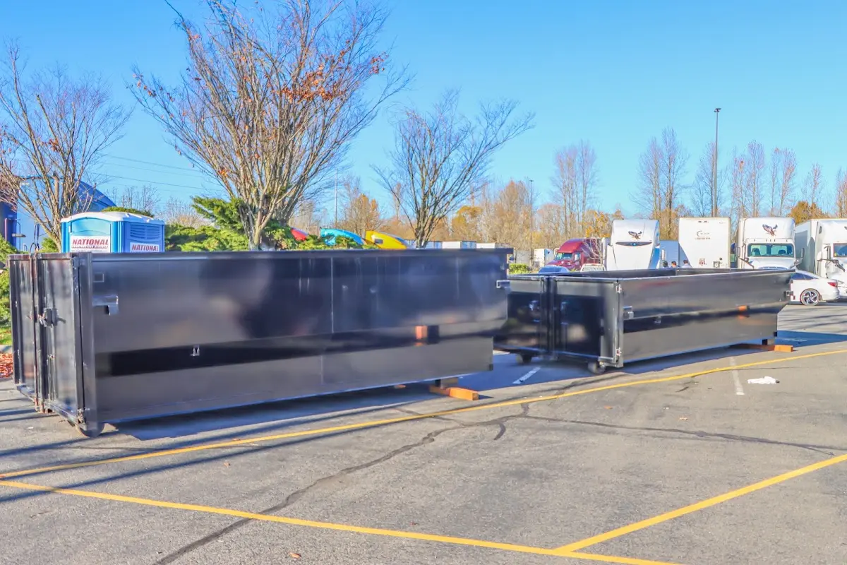 Professional dumpster rental service with roll-off container on residential driveway in Claremore